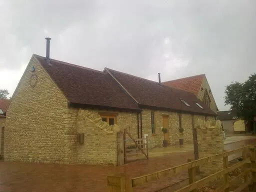 Converted stone barn with a new flue through the roof