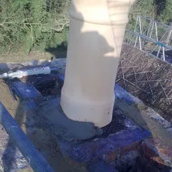 New chimney pot being bedded into fresh flaunching