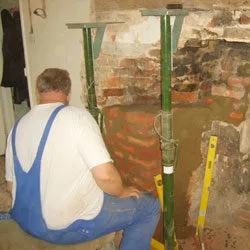 One of our team supporting a chimney breast with steel props during structural repairs